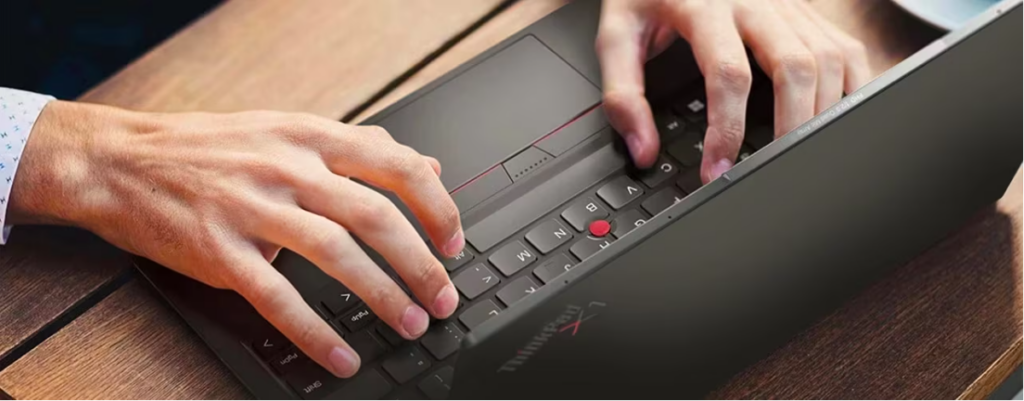 man's hands on laptop keyboard